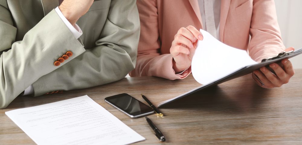 Human hands working with documents at the desk closeup